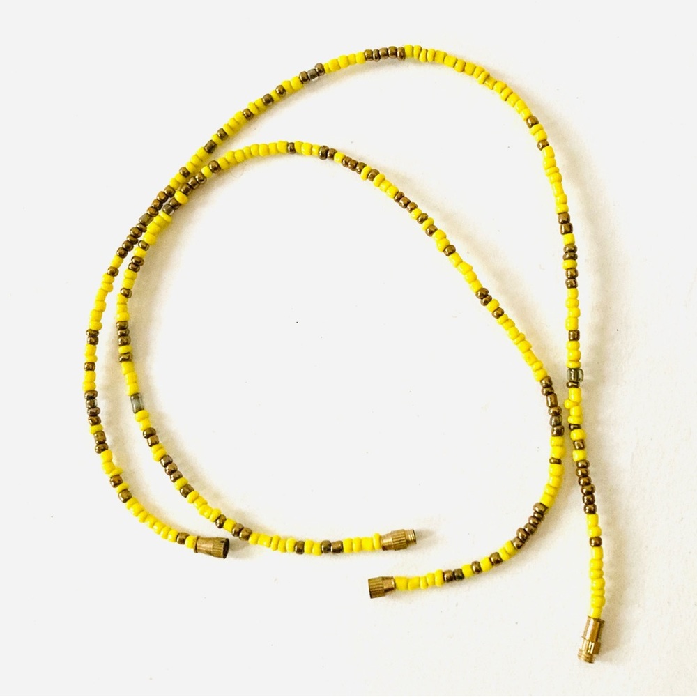 Pair of beaded yellow and gold color anklets